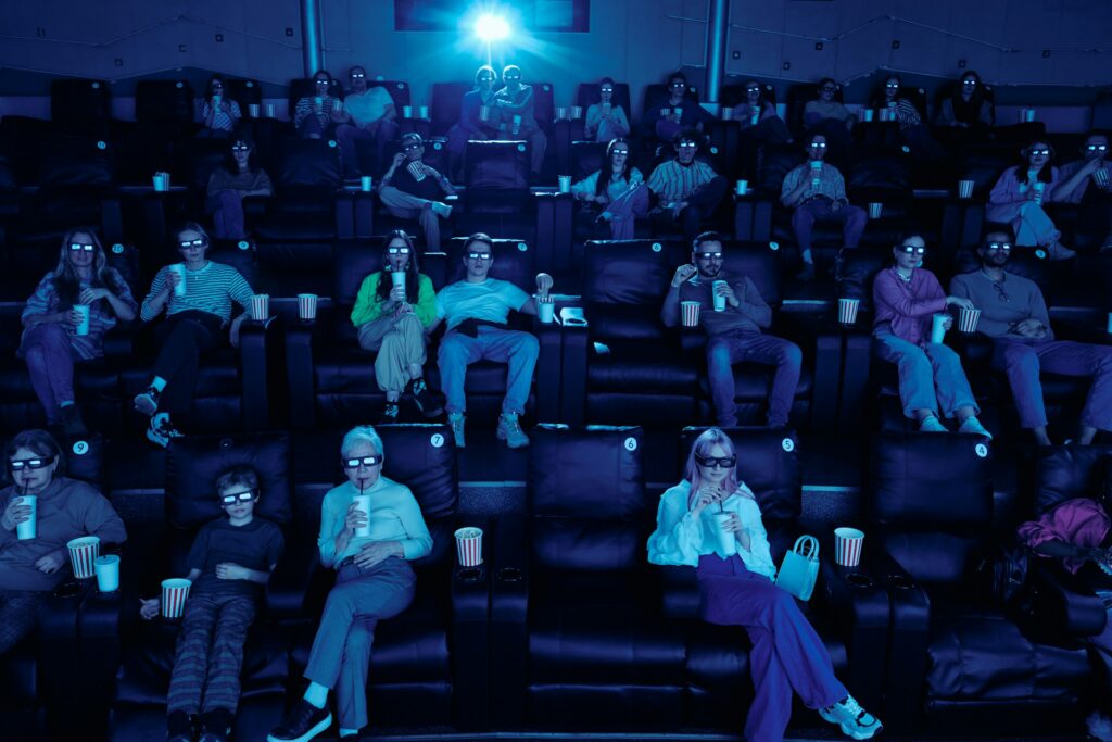 Cinema audience wearing 3D glasses; illustrative stock photograph