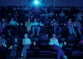 Cinema audience wearing 3D glasses; illustrative stock photograph