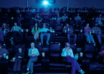 Cinema audience wearing 3D glasses; illustrative stock photograph