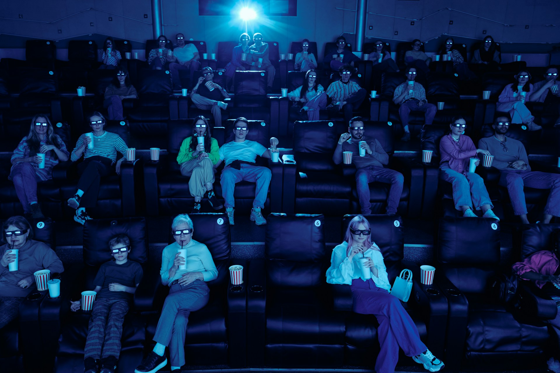Cinema audience wearing 3D glasses; illustrative stock photograph