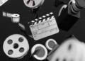 Three-dimensional illustration of a film reel, camera and clapperboard