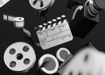 Three-dimensional illustration of a film reel, camera and clapperboard